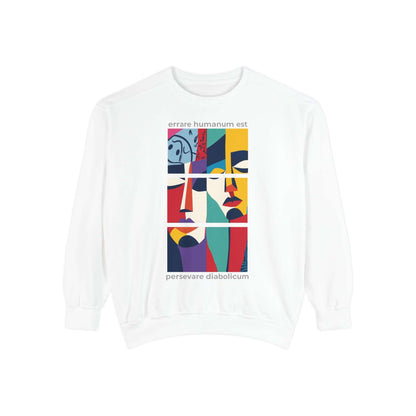 Colorful unisex sweatshirt with artistic face design and motivational text in a cozy, garment-dyed style.