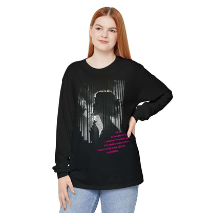 Woman wearing a black artistic long sleeve t-shirt featuring a unique design and vibrant lettering.