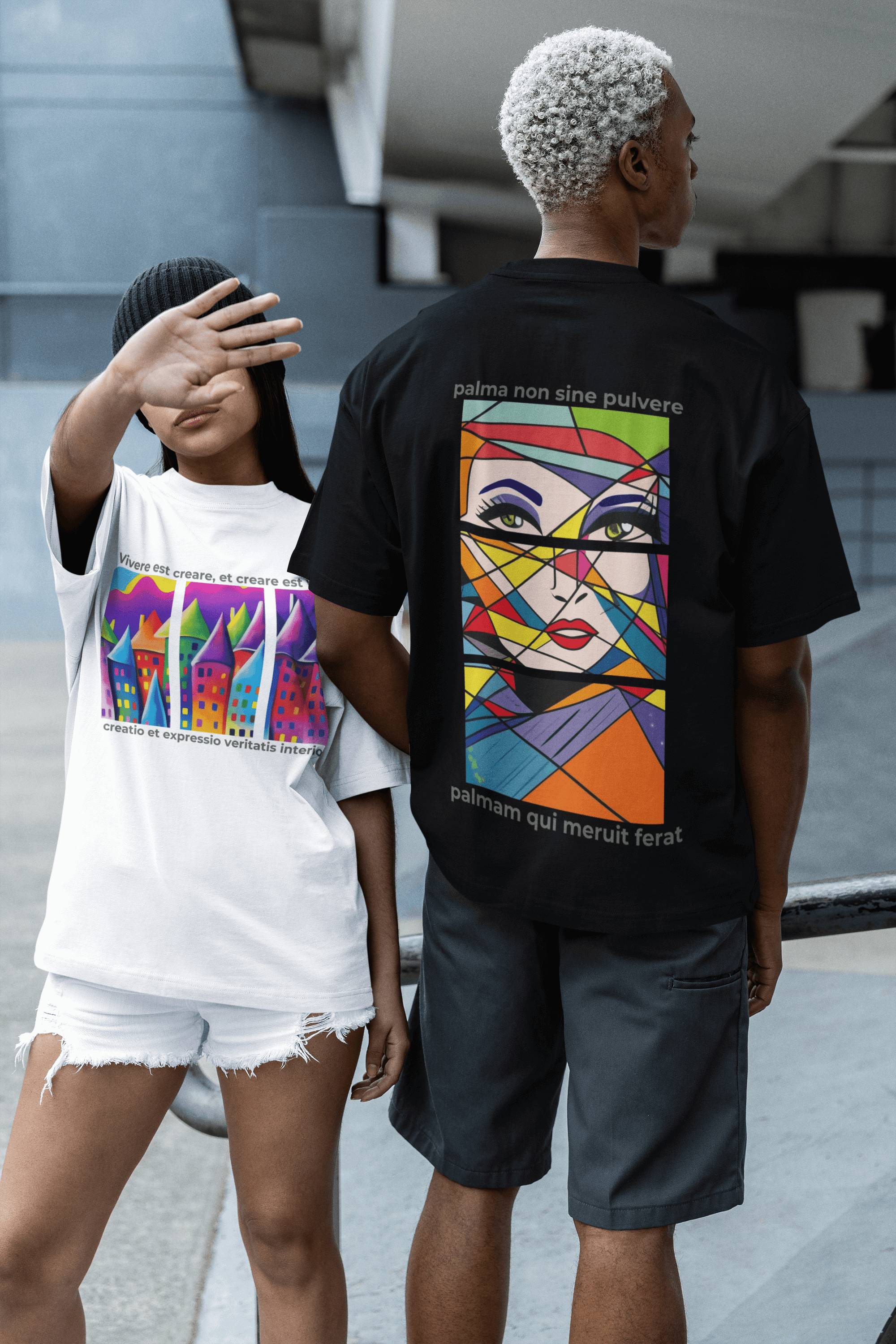 Two models showcasing oversized tees, one in a colorful graphic design and the other in a black artistic print.